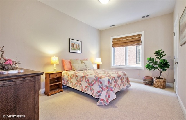2117 Harrison Street Evanston, IL 60201 - Photo 15 of 26 a bedroom with a bed and potted plant