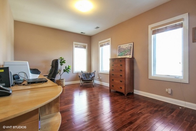 2117 Harrison Street Evanston, IL 60201 - Photo 17 of 26 a view of a workspace with furniture and a window