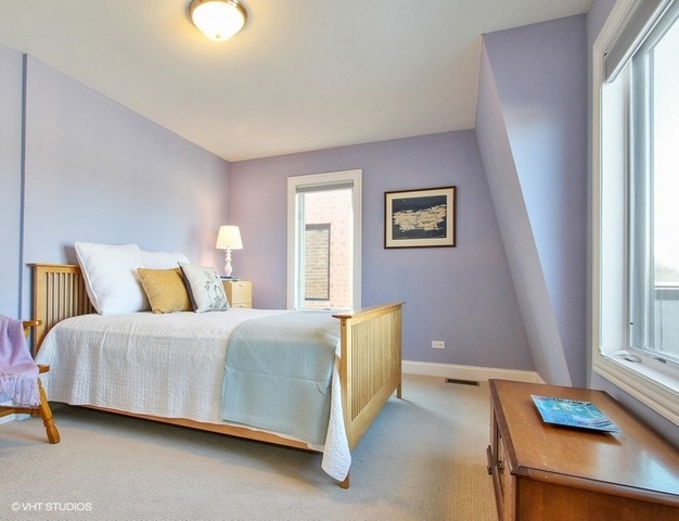 2117 Harrison Street Evanston, IL 60201 - Photo 19 of 26 a bedroom with a bed and a window