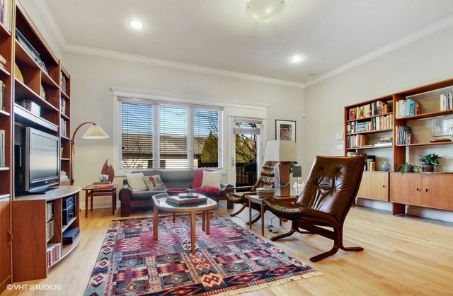 2117 Harrison Street Evanston, IL 60201 - Photo 6 of 26 a living room with furniture a rug and a flat screen tv