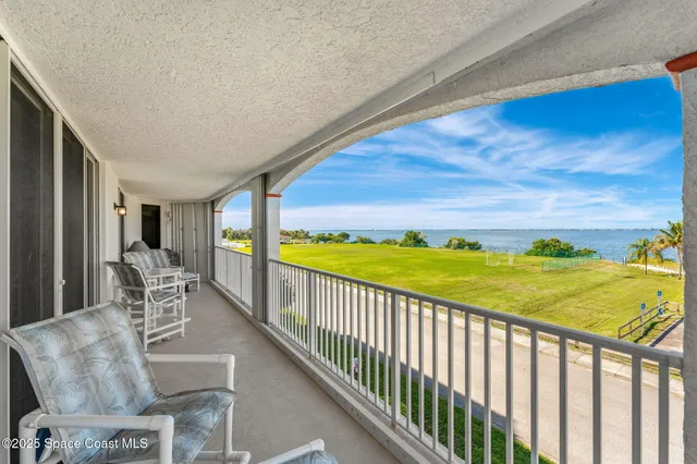 a living room with dining table and a wooden floor