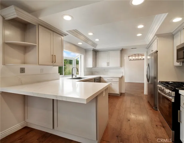a kitchen with kitchen island a sink appliances and cabinets