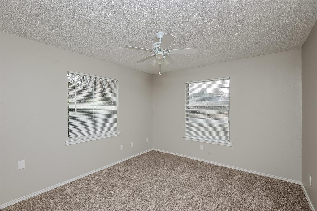 3001 Rufe Snow Drive Richland Hills, TX 76118 - Photo 11 of 15 an empty room with a window and a fan