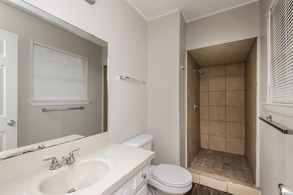 3001 Rufe Snow Drive Richland Hills, TX 76118 - Photo 12 of 15 a bathroom with a sink a toilet and shower