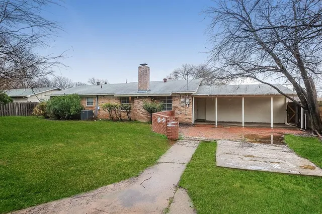 a front view of a house with a garden and plants