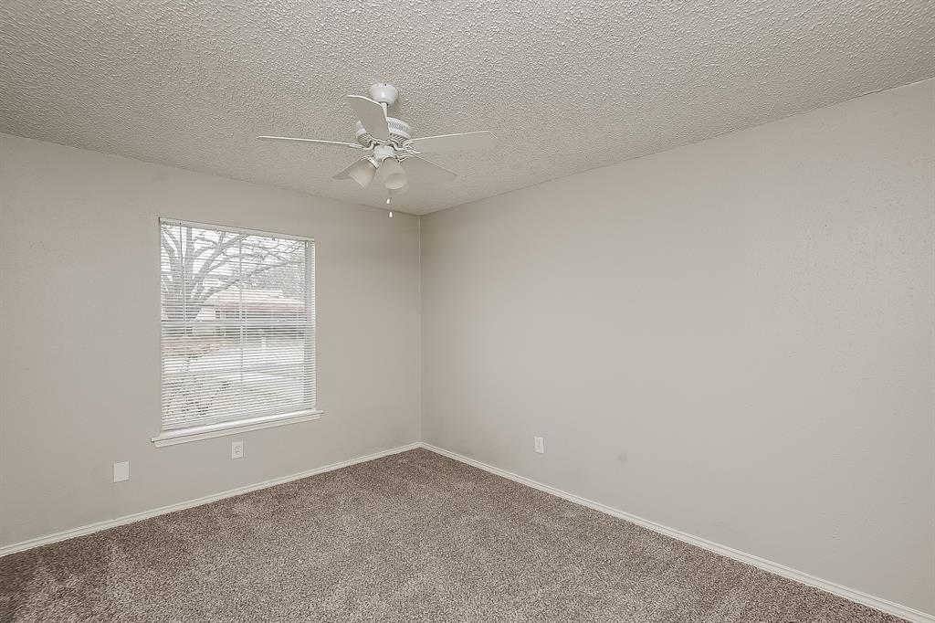 3001 Rufe Snow Drive Richland Hills, TX 76118 - Photo 10 of 15 an empty room with windows and fan