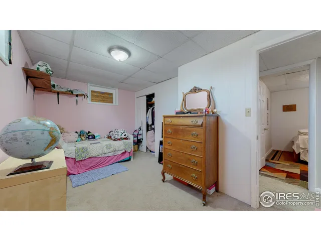 a living room with furniture and a baby crib