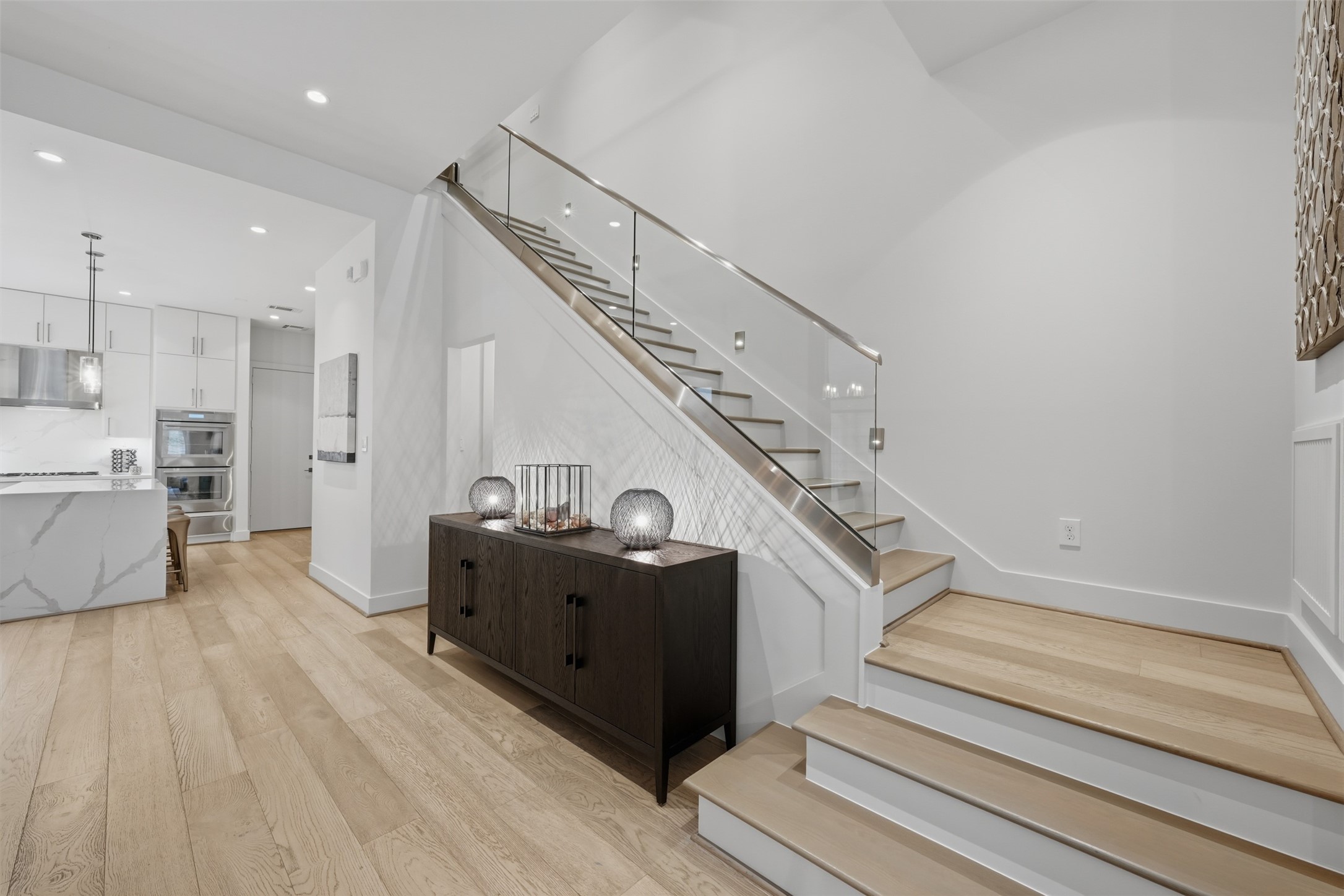 2114 McDuffie Street Houston, TX 77019 - Photo 14 of 45 The hallway pictured just beyond the credenza leads to the half bath and a large coat closet that extends under the staircase for additional 1st floor storage.