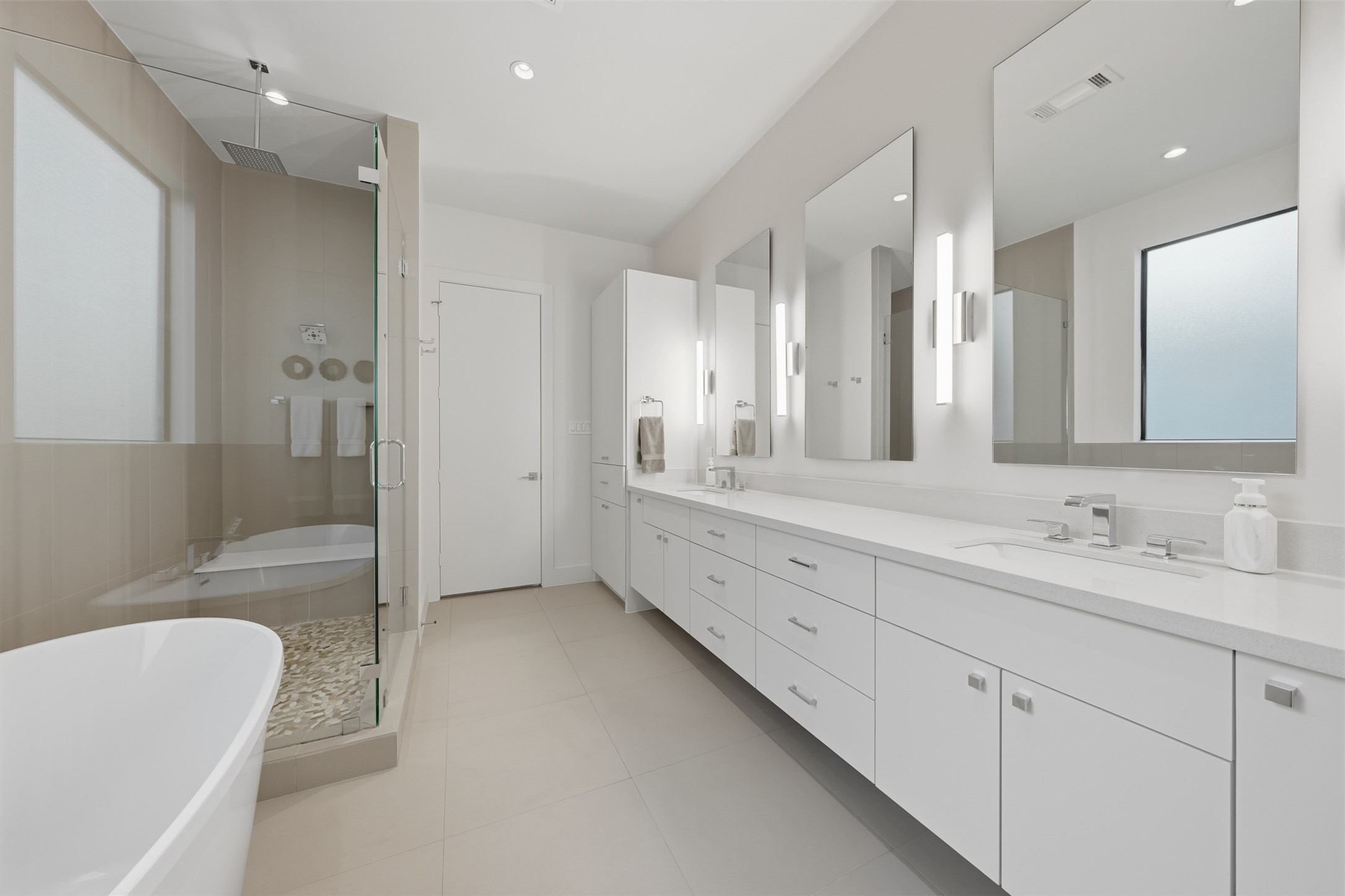 2114 McDuffie Street Houston, TX 77019 - Photo 28 of 45 The tranquil primary bathroom has double sinks, designer lighting, and expansive vanity space and storage.