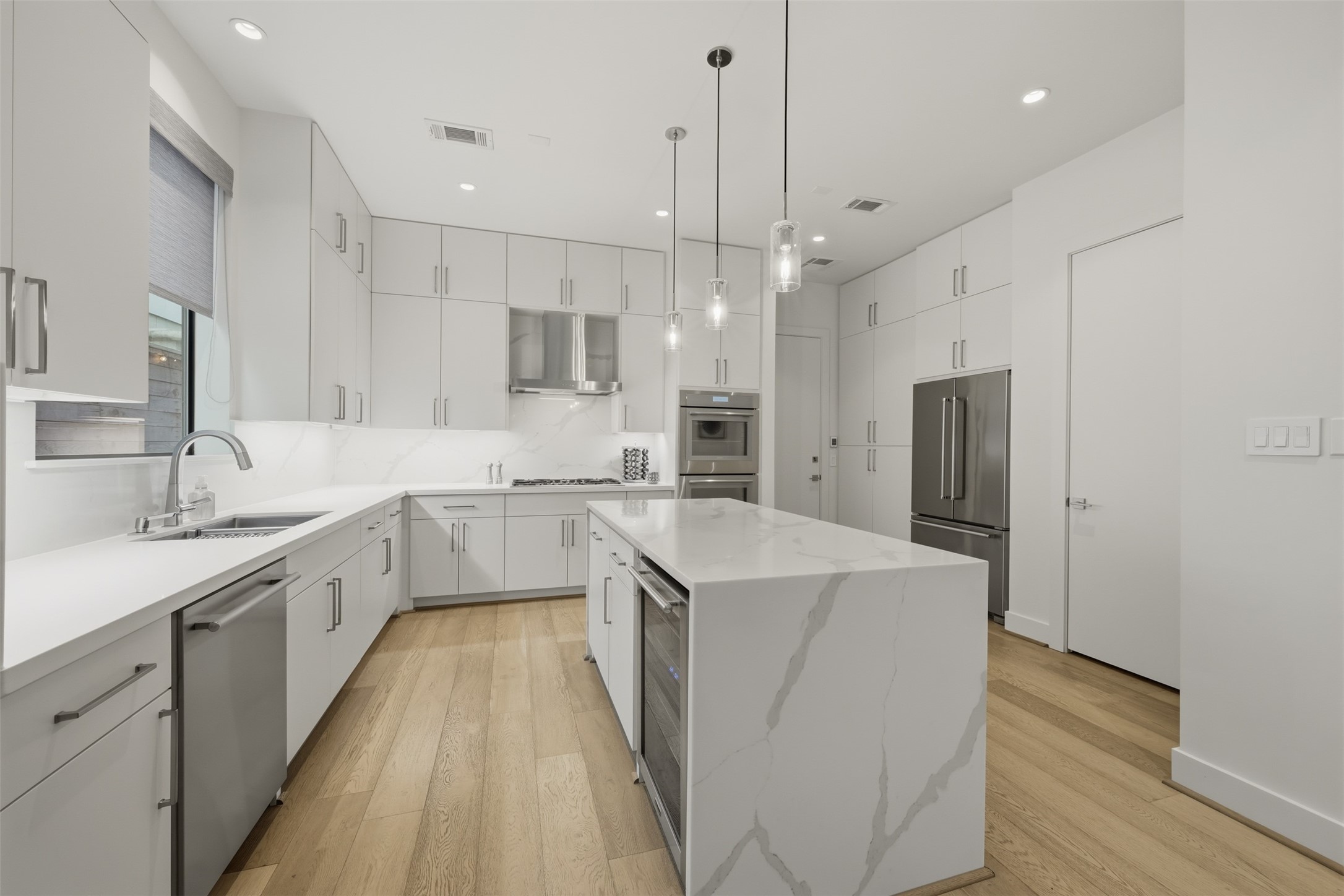 2114 McDuffie Street Houston, TX 77019 - Photo 5 of 45 The kitchen is adorned with quartz countertops and backsplash, stainless steel appliances and plenty of storage including a large pantry, and cabinet's with drawers.