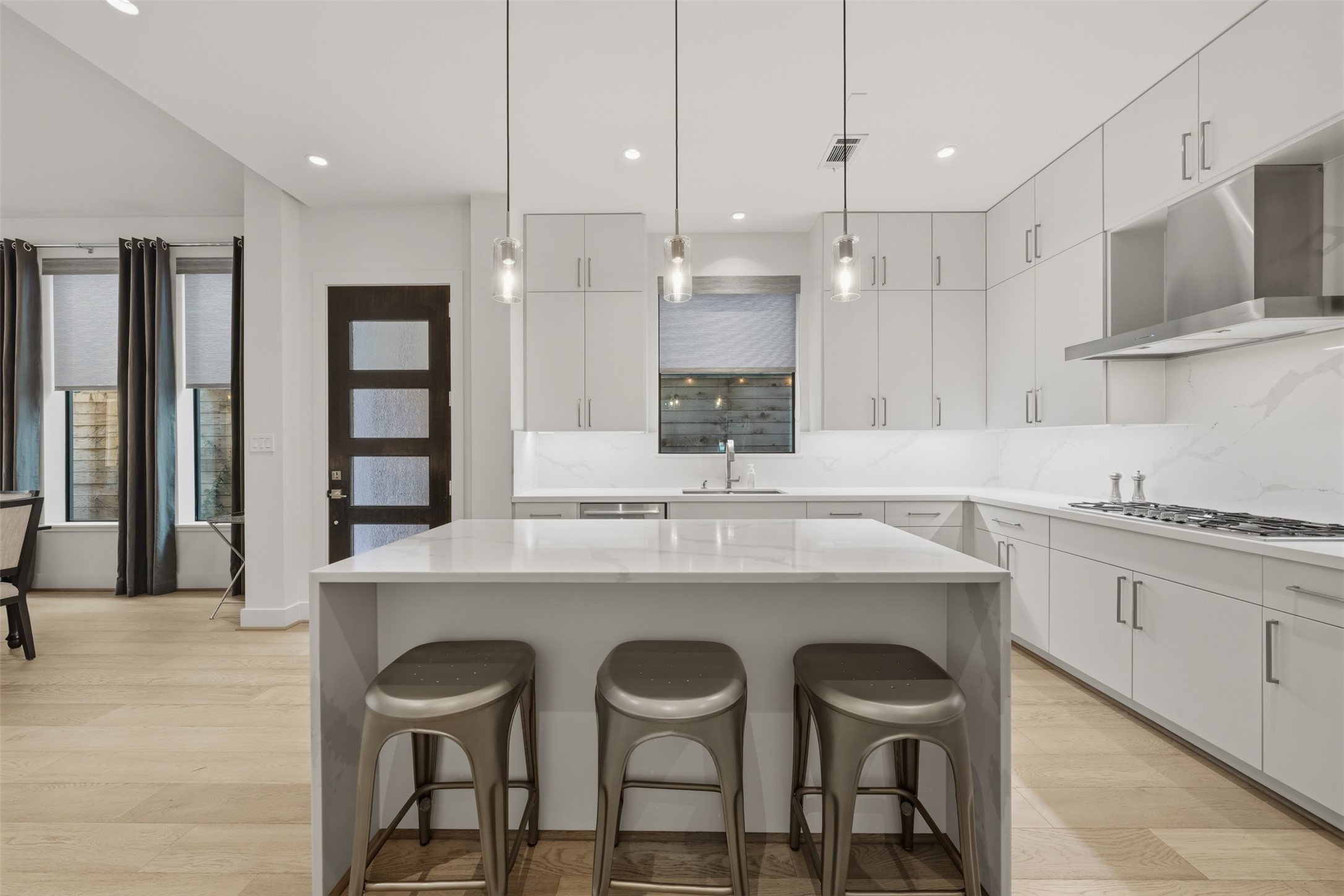 2114 McDuffie Street Houston, TX 77019 - Photo 7 of 45 The upgraded double waterfall edge island enhances the contemporary style.