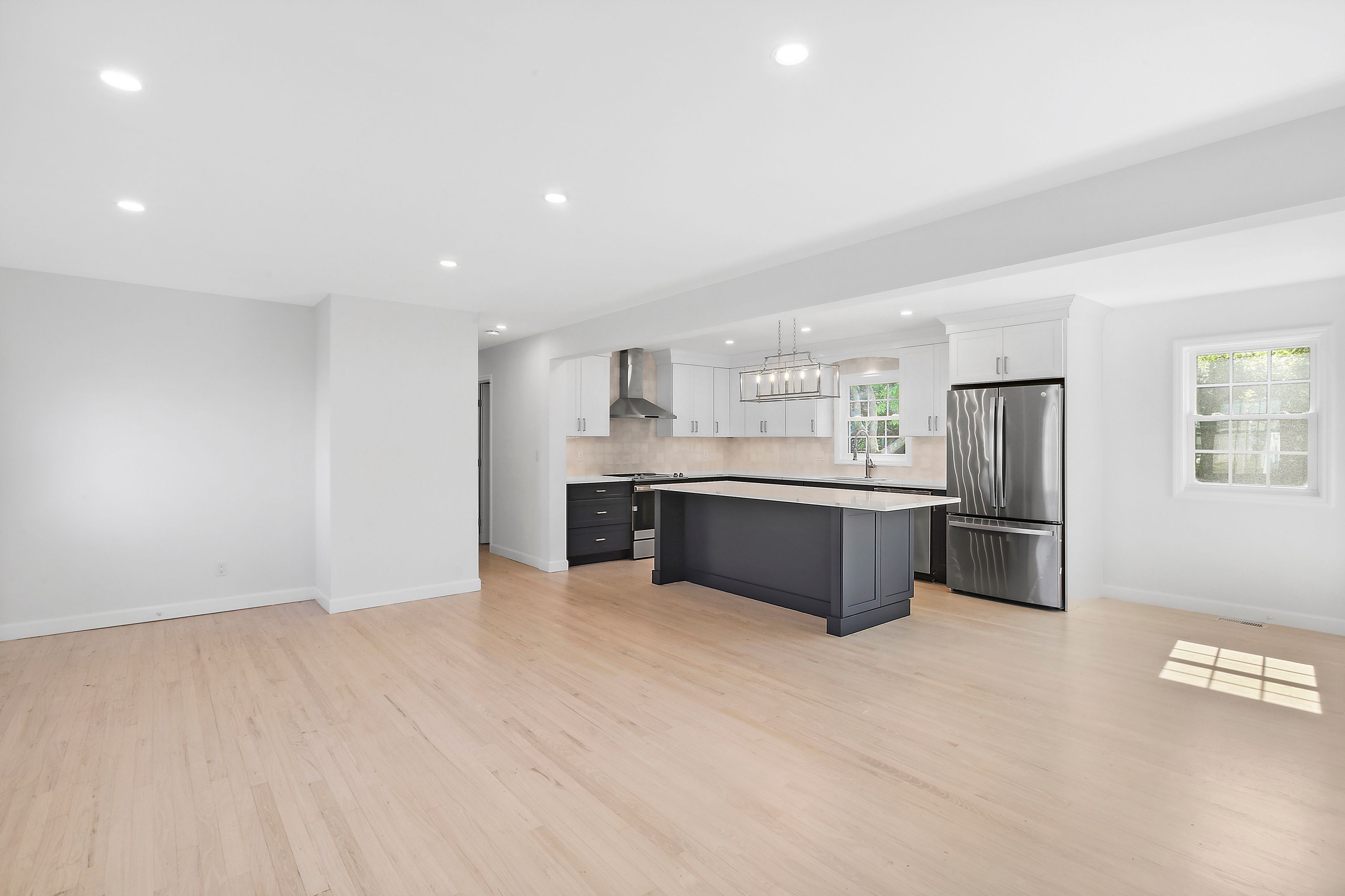 6 Whiting Road East Quogue, NY 11942 - Photo 2 of 18 a large kitchen with a large counter top stainless steel appliances and cabinets