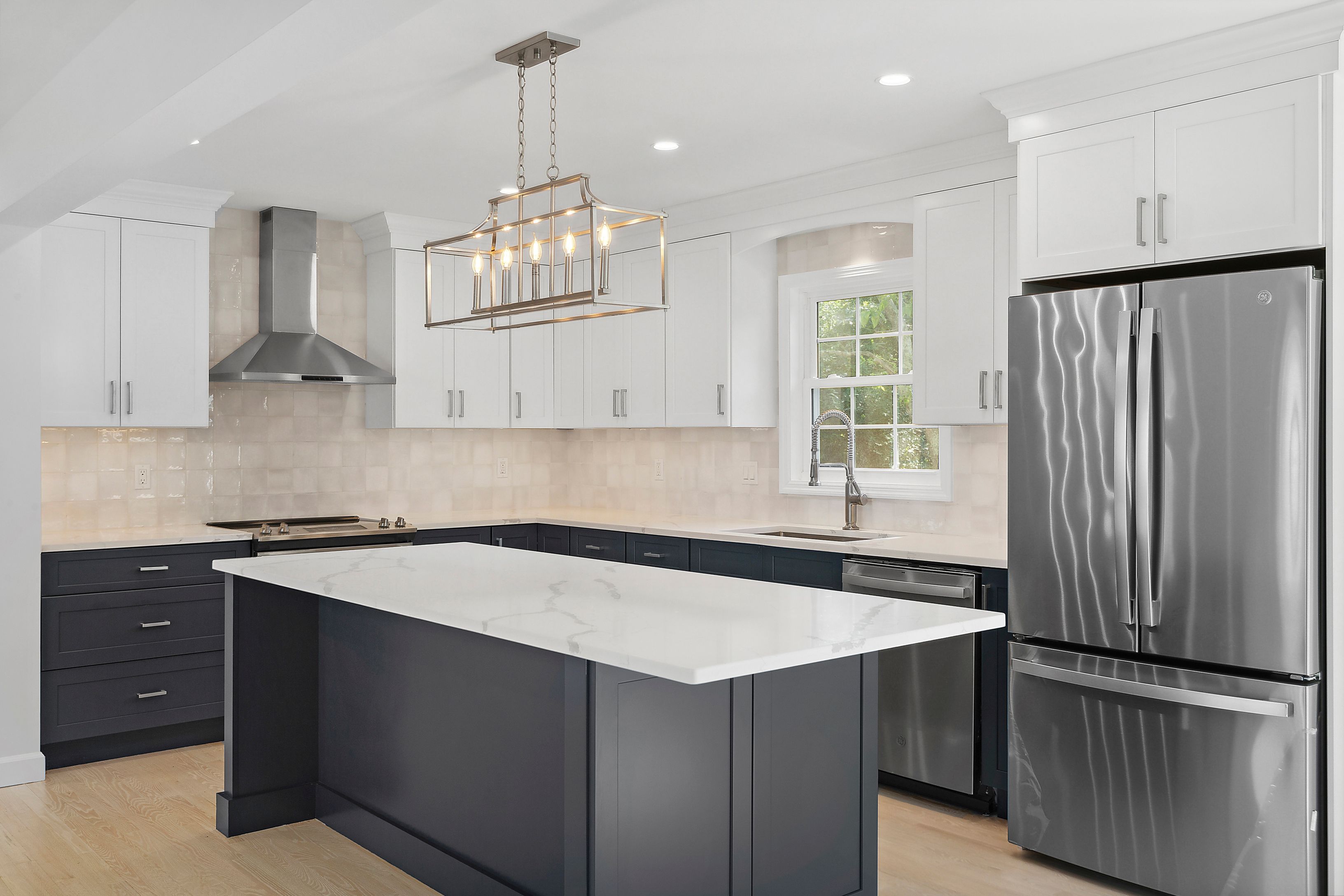 6 Whiting Road East Quogue, NY 11942 - Photo 4 of 18 a kitchen that has a sink and a stove in it