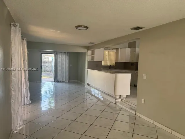 a kitchen with granite countertop a sink and cabinets