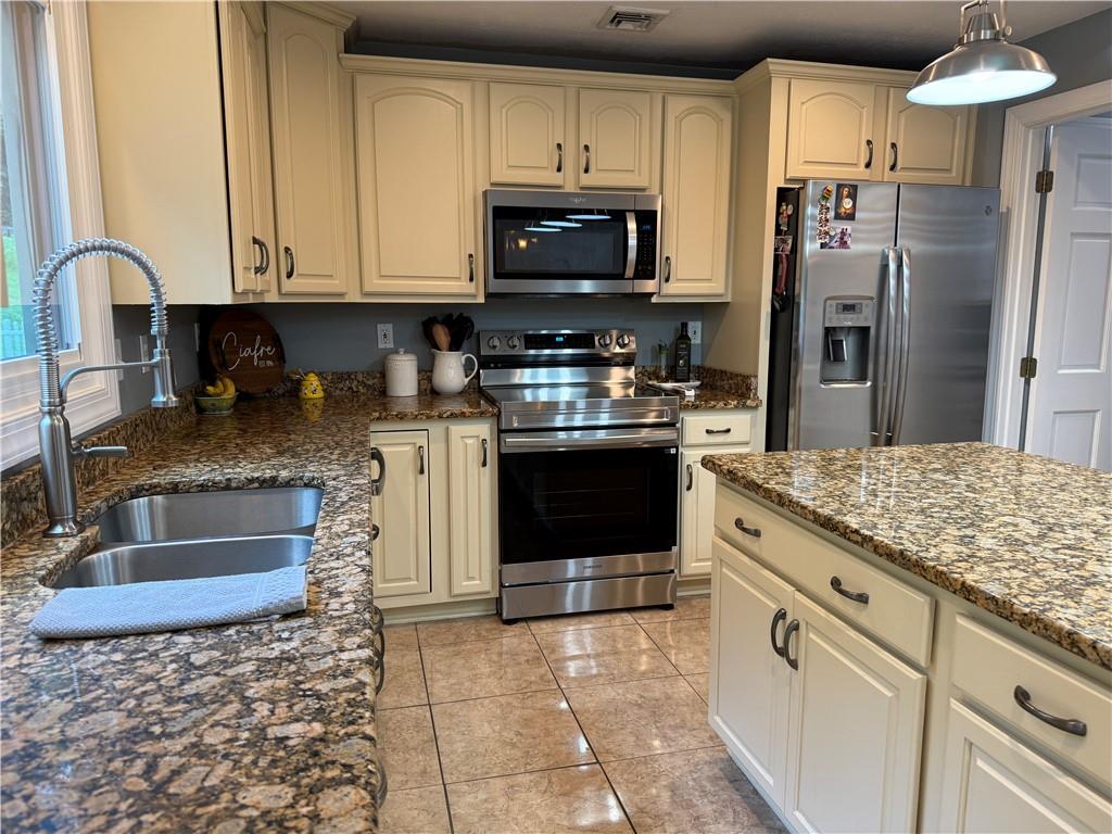 293 Sandy Hill Road Valencia, PA 16059 - Photo 29 of 50 a kitchen with stainless steel appliances granite countertop a stove a sink and a microwave