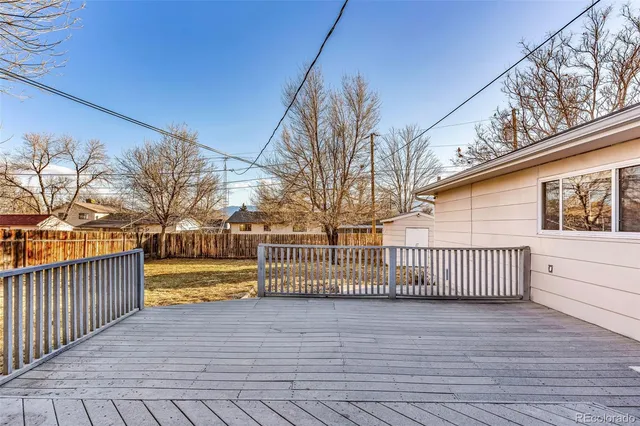 a view of a house with a wooden fence
