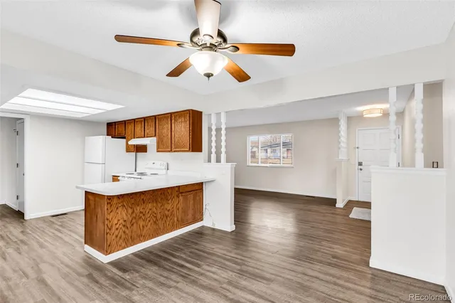 a view hallway with wooden floor and ceiling fan