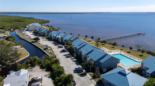 an aerial view of a houses with a yard
