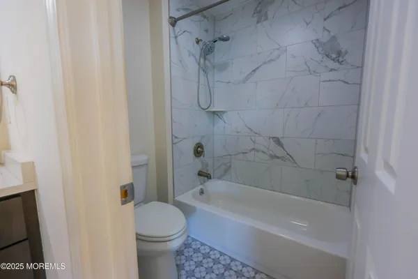 a bathroom with a bathtub and a toilet