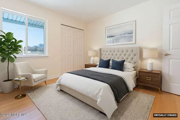 a bedroom with a bed and a potted plant