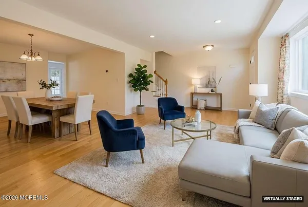 a living room with furniture and a dining table
