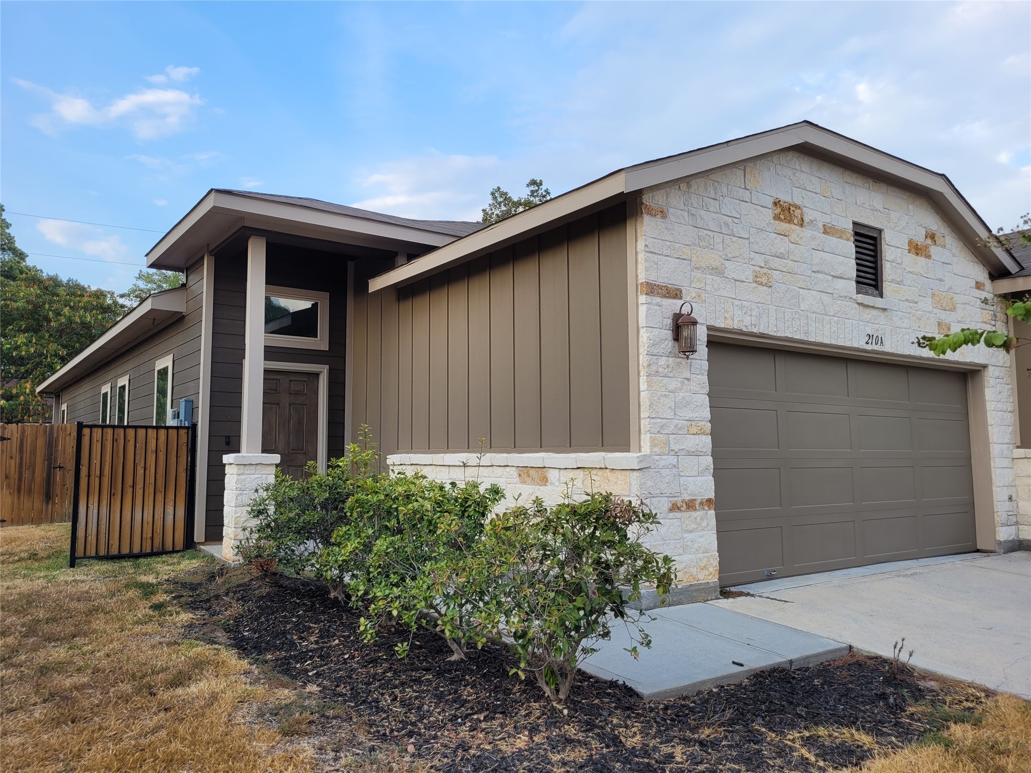 210 Oakcrest, Unit A Conroe, TX 77304 - Photo 1 of 17 a front view of a house with garden