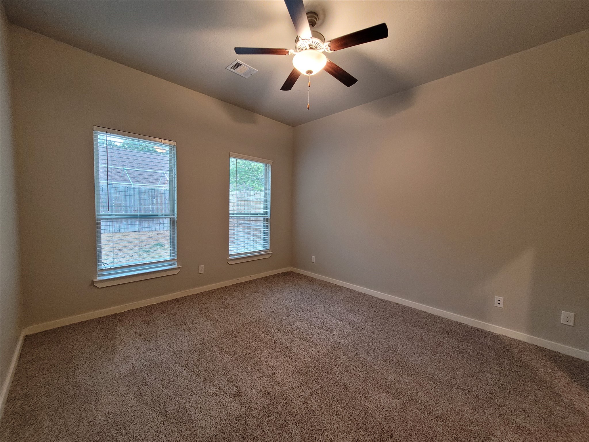 210 Oakcrest, Unit A Conroe, TX 77304 - Photo 11 of 17 a view of room with ceiling fan and window