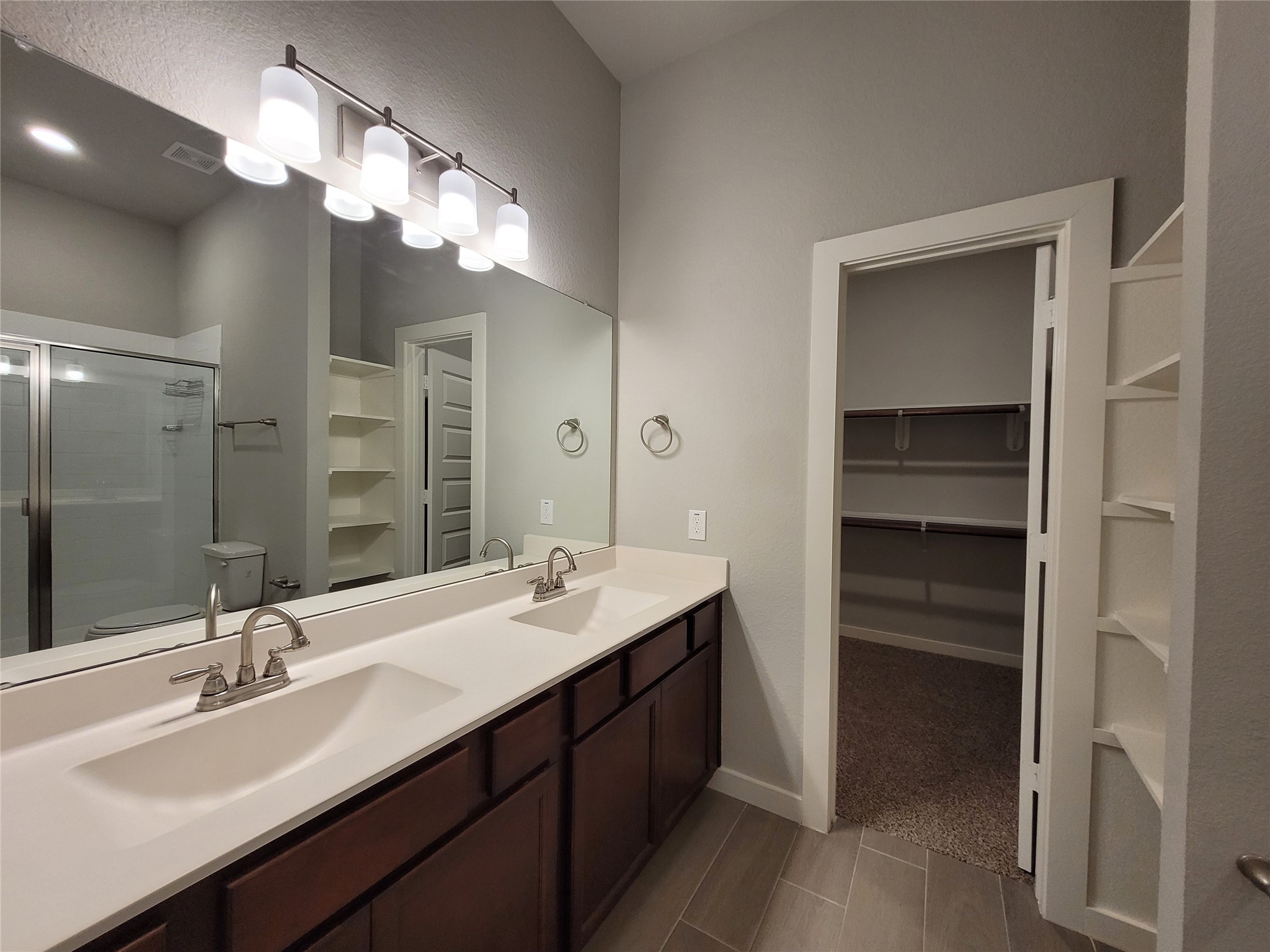 210 Oakcrest, Unit A Conroe, TX 77304 - Photo 13 of 17 a bathroom with a double vanity sink and a mirror