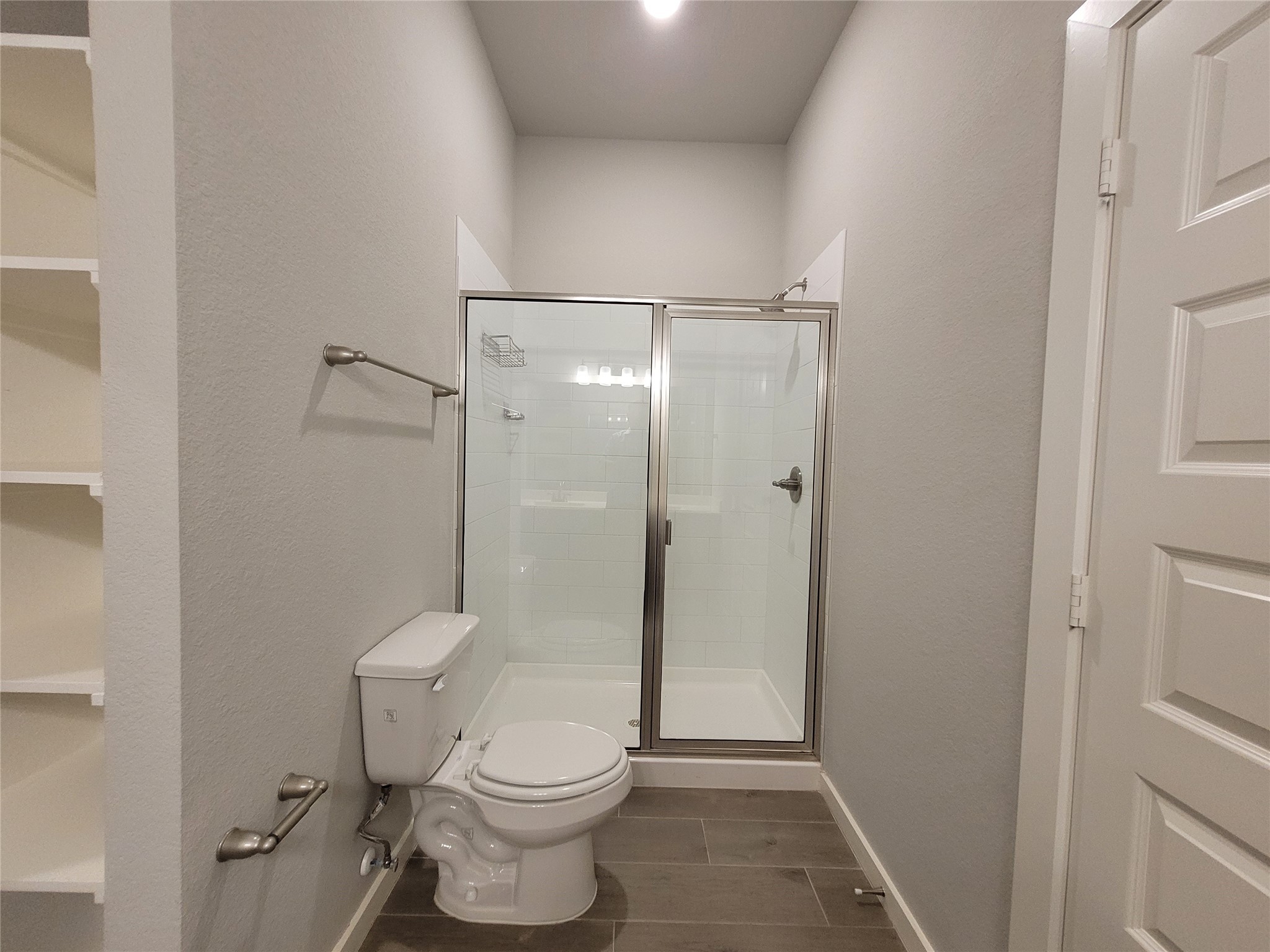 210 Oakcrest, Unit A Conroe, TX 77304 - Photo 14 of 17 a bathroom with a toilet and a shower