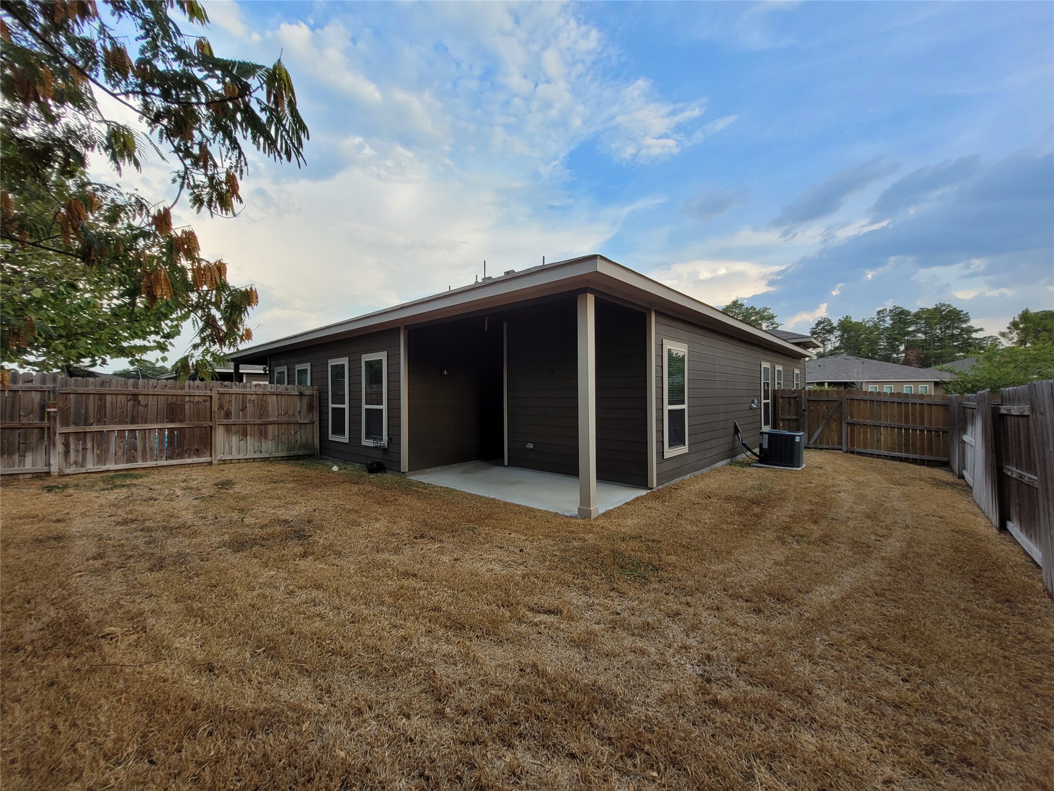 210 Oakcrest, Unit A Conroe, TX 77304 - Photo 16 of 17 a house with trees in the background