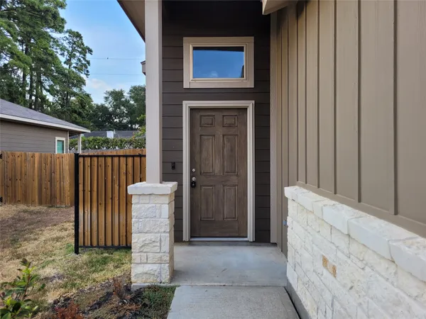 a front view of a house with a fence and a gate