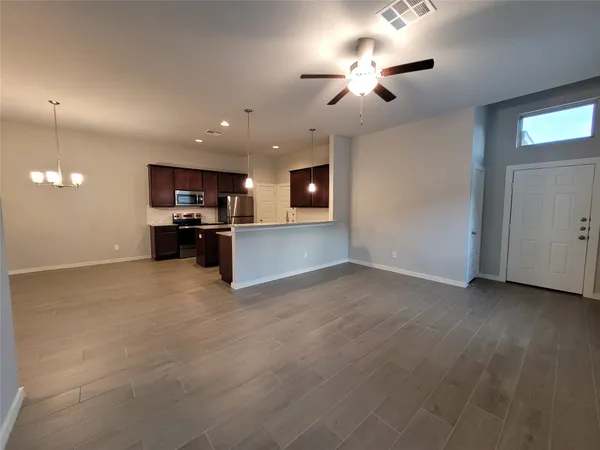 a kitchen with stainless steel appliances granite countertop wooden cabinets a stove top oven a sink and dishwasher