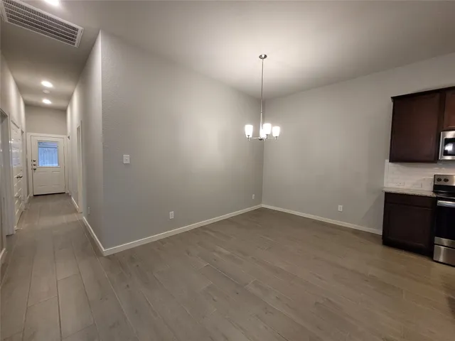 a kitchen with stainless steel appliances granite countertop wooden cabinets a stove top oven a sink and dishwasher