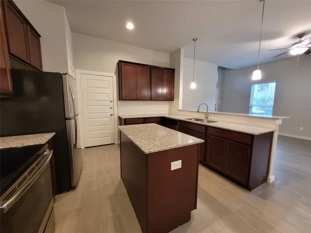 a kitchen with a sink and chandelier