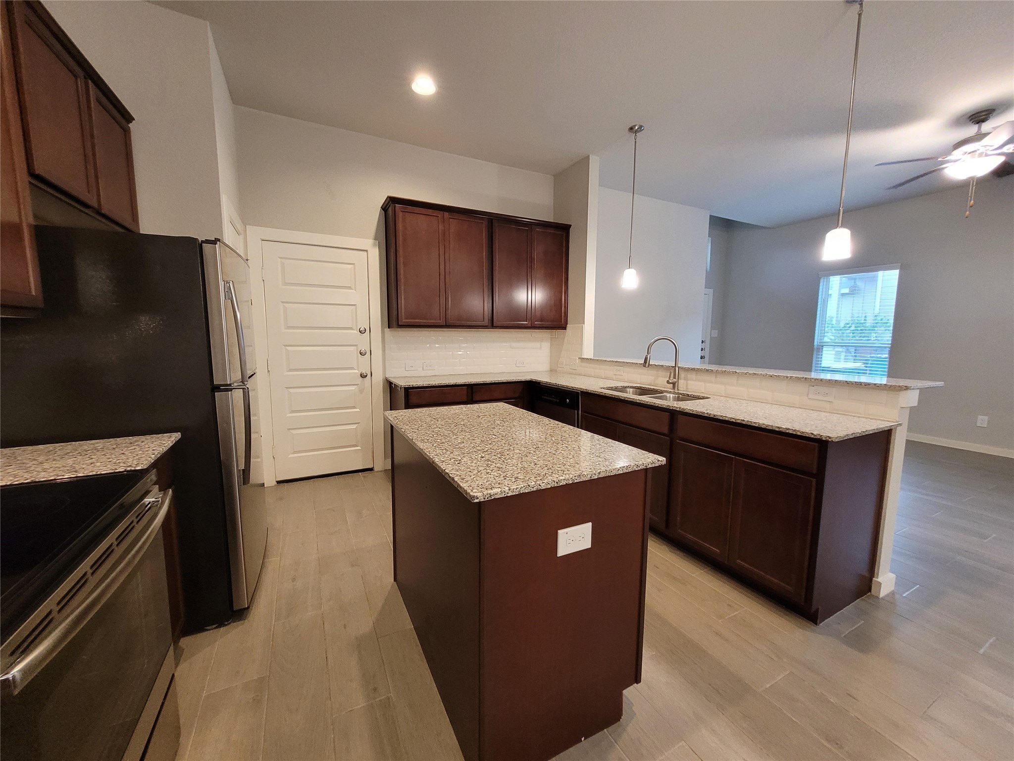 210 Oakcrest, Unit A Conroe, TX 77304 - Photo 6 of 17 a kitchen with a sink a counter top space and stainless steel appliances