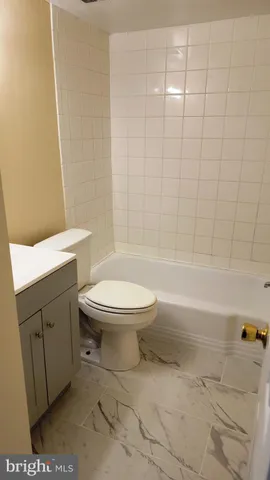 a bathroom with a toilet a sink and bathtub