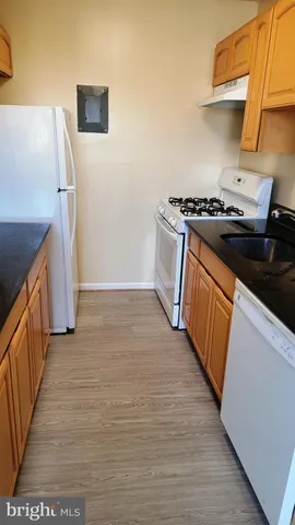 a kitchen with granite countertop a stove and a refrigerator