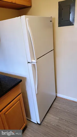 a utility room with wooden floor washer and dryer