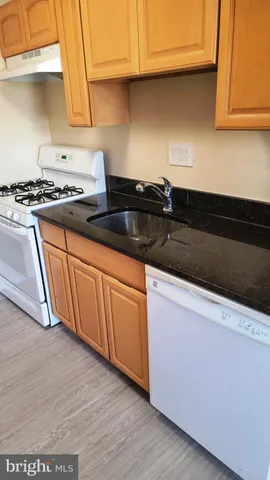 a kitchen with granite countertop cabinets a sink and dishwasher