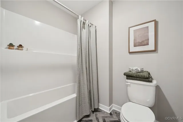 a bathroom with a toilet a sink and bathtub