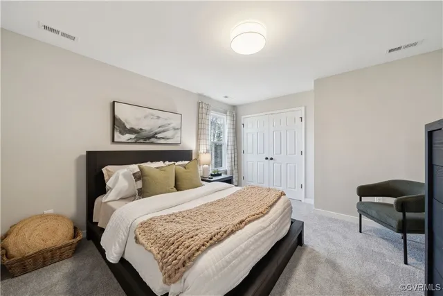 a bedroom with bed and a painting on the wall