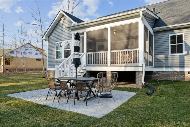 a view of a house with backyard porch and sitting area
