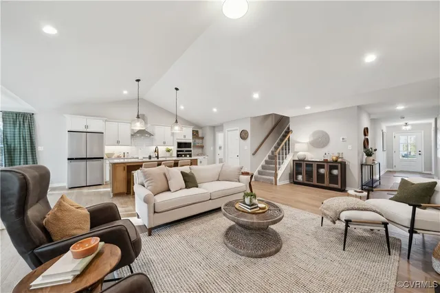 a living room with furniture kitchen view and a table
