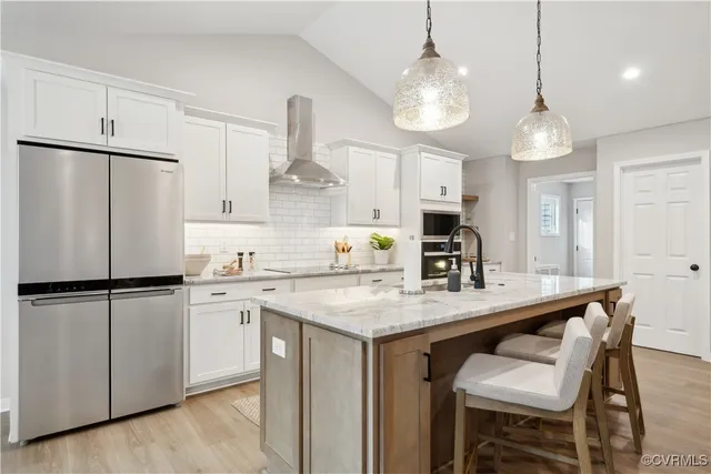 a kitchen with kitchen island granite countertop a sink a center island and cabinets