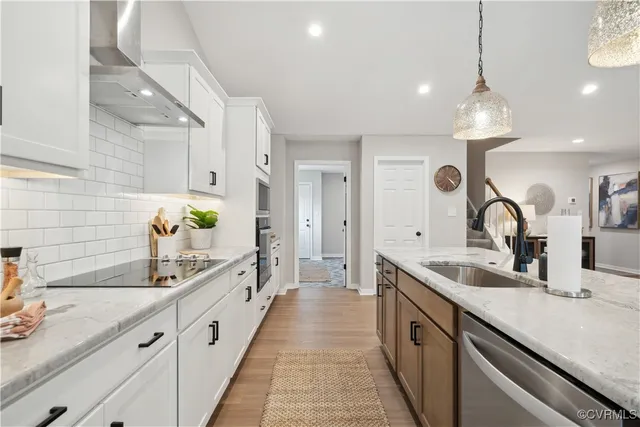 a large kitchen with granite countertop a sink and a refrigerator