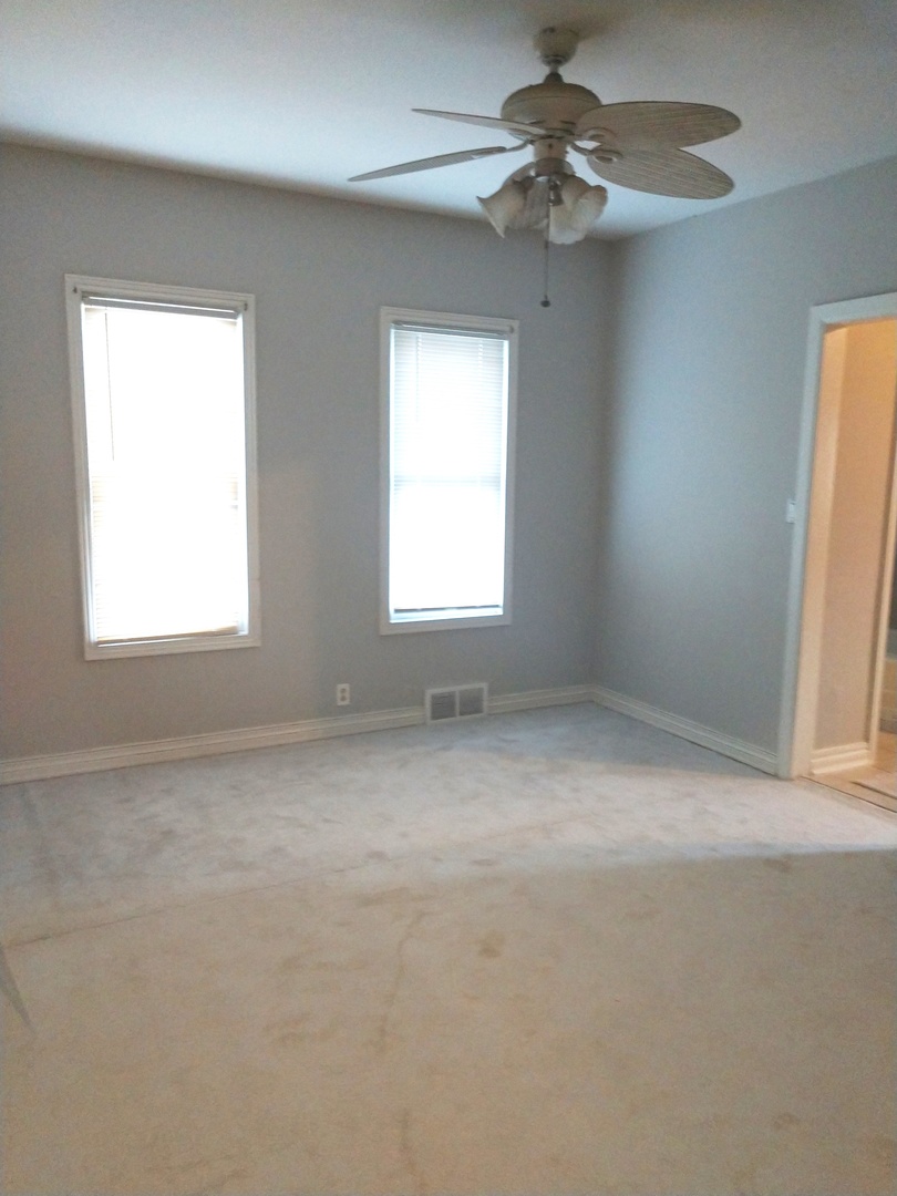 853 Adams Street, Unit 1 Waukegan, IL 60085 - Photo 2 of 9 a view of a window in an empty room
