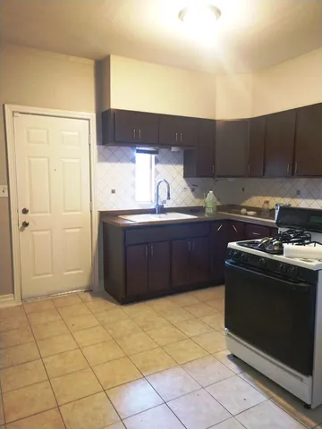 a kitchen with a sink and a stove top oven