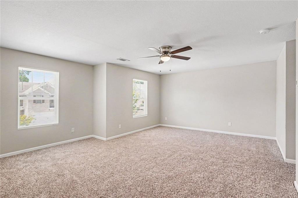 10941 Wheeler Trace Hampton, GA 30228 - Photo 10 of 21 a view of an empty room with a window