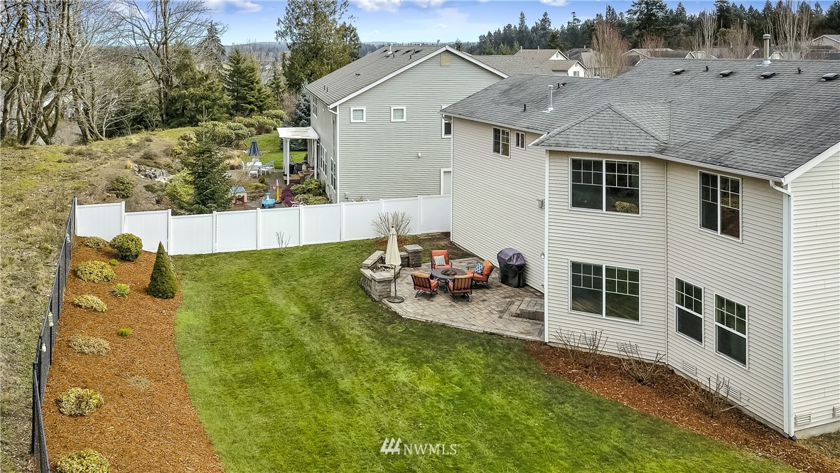 3141 Walker Road DuPont, WA 98327 - Photo 2 of 18 a view of a white house with a big yard and large trees