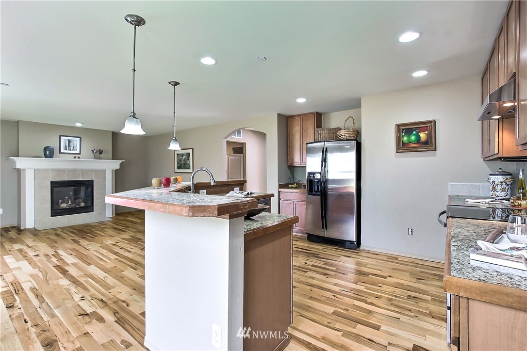 3141 Walker Road DuPont, WA 98327 - Photo 6 of 18 a kitchen with kitchen island a sink stove and refrigerator